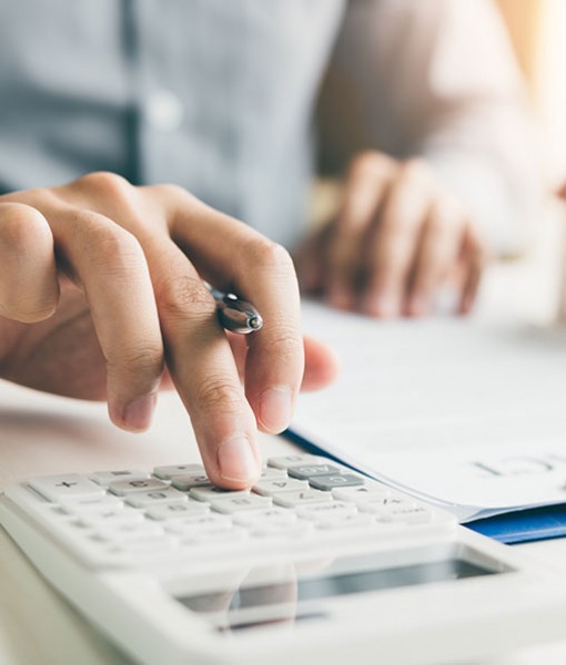 Hands using a calculator