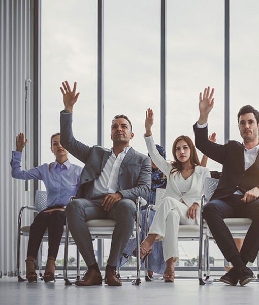 Group of people raising hands